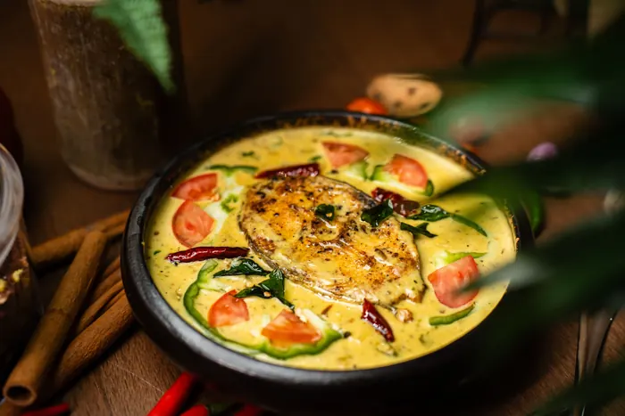 Fish in a creamy curry with tomato and herbs.