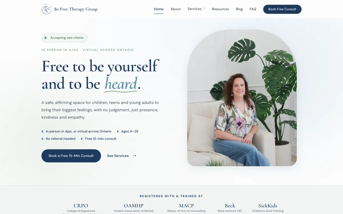 The new Be Free Therapy Group homepage on a computer: the headline Free to be yourself and to be heard, a short description, a Book a Free 15-Min Consult button, and a photo of Breana on a couch beside a plant.